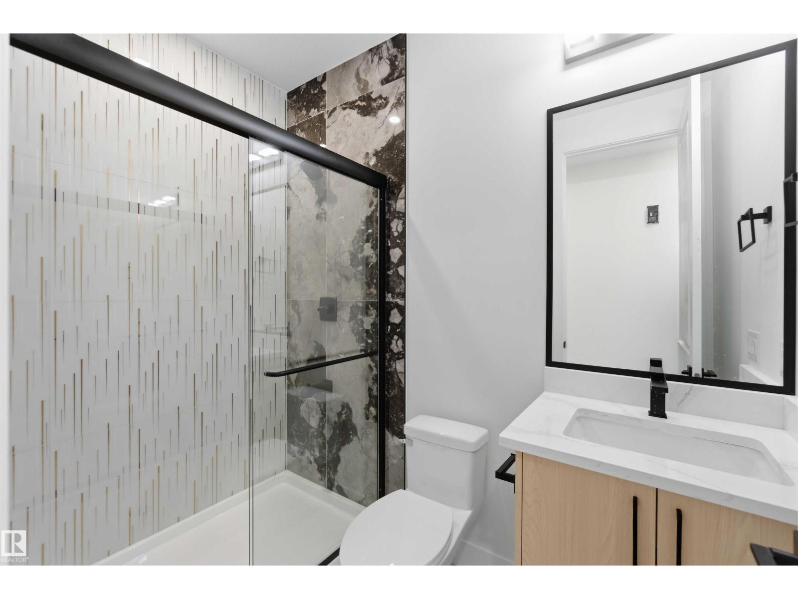 Bathroom vanity and marble shower